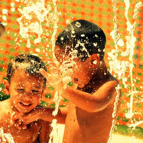 Kids Playing In A Fountain To Stay Cool